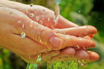 water splashing into hands